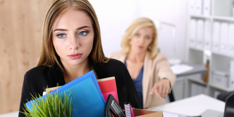 45107583 - boss dismissing an employee. dejected fired office worker carrying a box full of belongings.