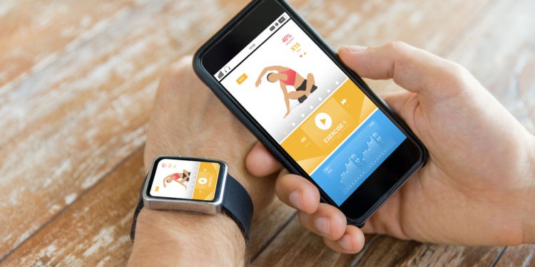 sport, fitness, technology, responsive design and people concept - close up of male hand holding smart phone and wearing watch with sports application on screen