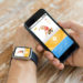 sport, fitness, technology, responsive design and people concept - close up of male hand holding smart phone and wearing watch with sports application on screen
