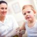 Female pediatrician makes vaccination to small boy