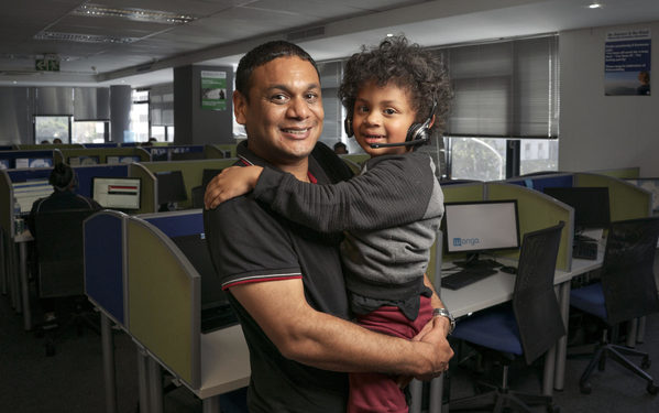 Fahiem Abrahams, 37, holds his son Fawad, 4, for a portrait taken at the Wonga call centre where Fahiem works in Cape Town, South Africa on 7 May 2019. Fawad, who lives with autism, communicates primarily through musical intonation rather than words. “For someone who’s non-verbal, he’s very vocal,” Fahiem says. “A year and a half ago he was basically mute. Now anything he says is music to my ears. He sings all the time, but I can’t make out what he’s saying.” In January 2019, Fawad began attending Alpha School for Learners with Autism. In the months since then, he has made tremendous strides forward, passing developmental milestones that his parents worried he might never reach. While Fawad’s enrollment at Alpha School has been a life-changing event, it has also created new challenges for the family. The school is located far from Fahiem’s office and his family's home, requiring a two-hour commute each morning. But Fahiem says that “just being there for your kids” is the most important part of being a dad.

Fawad, age 4, wanders into the room, his thick mop of long, loose curls swaying with each small footfall, with a melodic string of sounds tumbling from his smiling lips. “For someone who’s non-verbal, he’s very vocal,” says Fawad’s father, Fahiem Abrahams, 37. “A year and a half ago he was basically mute. Now... he sings all the time, but I can’t make out what he’s saying.” Fawad, who lives with autism, is the middle of three children. His family lives in Bonteheuwel, Western Cape, South Africa. “If you go to an autism workshop, you’ll see three fathers and 40 mothers,” Fahiem says. “I don’t know why fathers are so disengaged.”

Taheera, Fahiem's wife, interjects: “Fathers struggle to accept (autism), where mothers have no choice but to accept. It’s a maternal value to accept, where fathers don’t want to give up their dreams.”

Fahiem nods his head in agreement.At first, Faheim and Taheera felt helpl