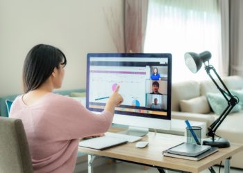 Asian business woman talking to her colleagues about plan in video conference. Multiethnic business team using computer for a online meeting in video call. Group of people smart working from home.