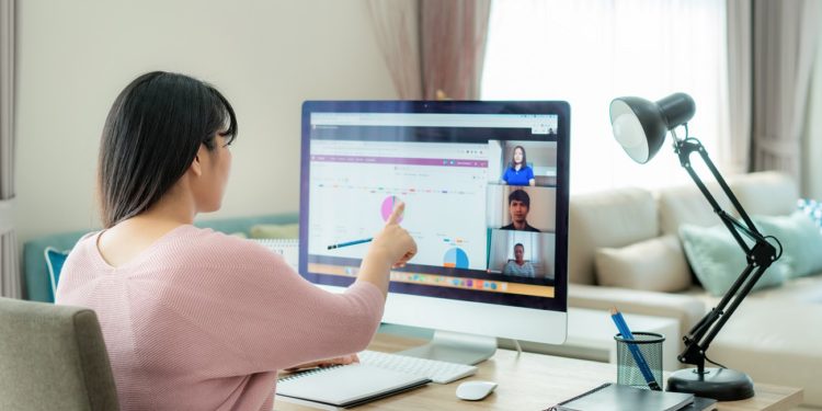 Asian business woman talking to her colleagues about plan in video conference. Multiethnic business team using computer for a online meeting in video call. Group of people smart working from home.