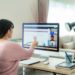 Asian business woman talking to her colleagues about plan in video conference. Multiethnic business team using computer for a online meeting in video call. Group of people smart working from home.