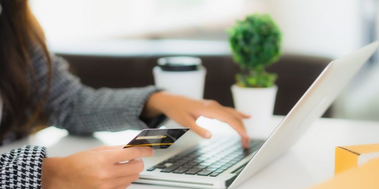 Portrait beautiful young asian woman use credit card with laptop for online shopping item