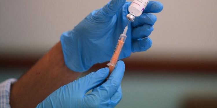 Pharmacist, Minhal Master prepares a dose of the AstraZeneca/Oxford Covid-19 vaccine at a temporary vaccination centre, staffed by pharmacists and pharmacist assistants, at the Al-Abbas Islamic Centre in Birmingham, West Midlands on February 4, 2021. - Oxford University announced on Thursday it will launch a medical trial alternating doses of Covid-19 vaccines created by different manufacturers, the first study of its kind. (Photo by Oli SCARFF / AFP)
