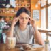 Young female sitting in a cafe indoors rest sick