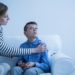 Mother and her autistic son sitting on the sofa