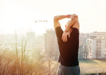Young man stretching outdoor looking scenic view - Male sportsman workout in the city looking future - sport, excercise, achievement concept