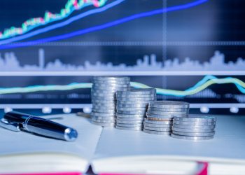 Stack of money coin with trading graph. financial investment concept use for background.