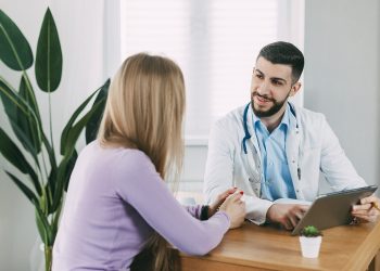 The male doctor consults the patient, shows information about his illness and talks about the medical examination