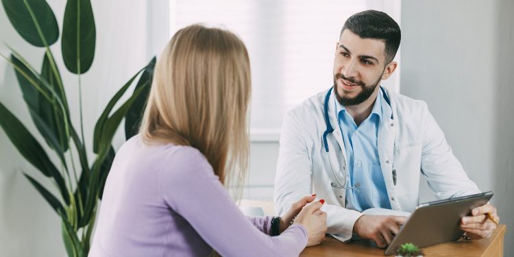 The male doctor consults the patient, shows information about his illness and talks about the medical examination