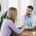 The male doctor consults the patient, shows information about his illness and talks about the medical examination