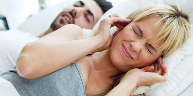 Portrait of woman who can not sleep because her husband snores.