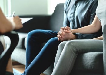 Counseling and therapy for couple and family. Adoption, psychology or psychotherapy concept. Session with psychiatrist or psychologist. Husband and wife with marriage counselor. Man, woman and doctor.