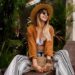 Vacation time in Asia. Fashionable woman resting  in  resort, chilling near pool. Wearing bohemian summer accessories .