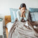 Woman with flu in bed, she use home medicine to handle sickness