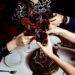 raised glasses of red wine and chocolate cake