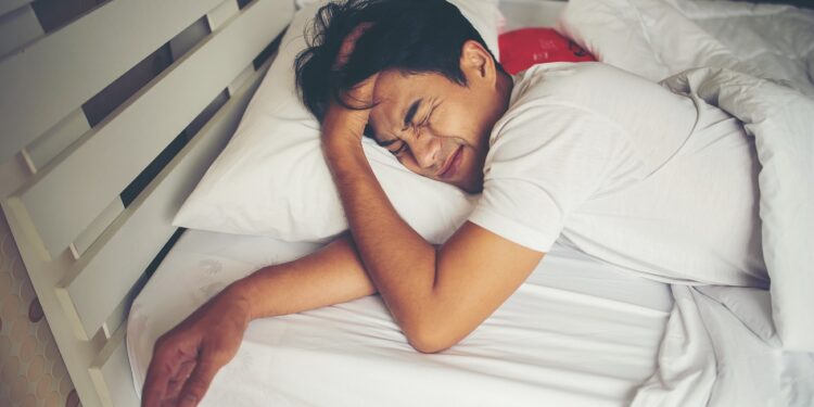 Man sleeping on bed in the morning