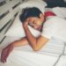 Man sleeping on bed in the morning