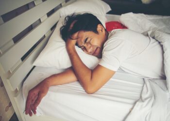 Man sleeping on bed in the morning