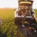 Young family with kids travelling by car, stopped in the field