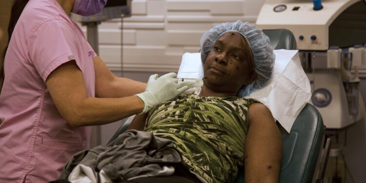 Dr. Sandra Lee injects Brittney to numb the area before surgery.