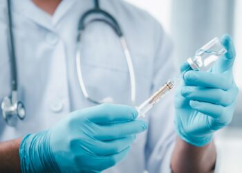 Concept fight against virus covid-19 corona virus, doctor or scientist in laboratory holding a syringe with liquid vaccines for children or older adults,Concept:diseases,medical care,science.; Shutterstock ID 1690179541; ordering_party: CMS CMNO; job_project: not definded by user; purchase_order: Polly Lloyd; other:
