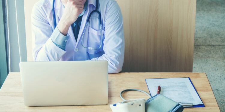 Doctor is working in office sitting, thinking about Disease problem of patient