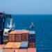 African wooden sailboat crossing container vessel way at close distance.; Shutterstock ID 1891608787; ordering_party: CMS CMNO; job_project: six-part Belt and Road series (Africa); purchase_order: Craig Moseley
