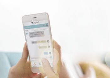 Woman texting on a couch