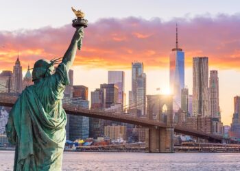 Statue Liberty and  New York city skyline at sunset,  in United States