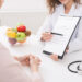 Food coaching. Professional dietitian explaining meal plan to patient at consultation