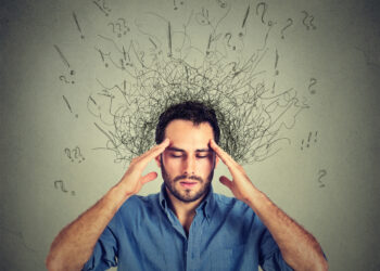 Closeup sad young man with worried stressed face expression and brain melting into lines question marks. Obsessive compulsive, adhd, anxiety disorders