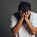 man stress out and cover his face by his hands