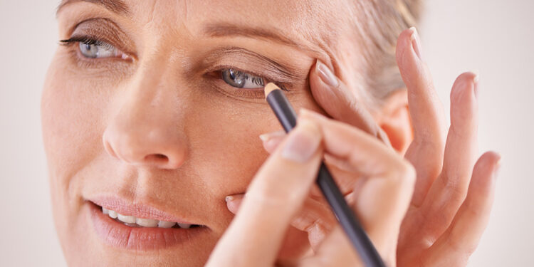 Woman applying eyeliner