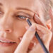 Woman applying eyeliner