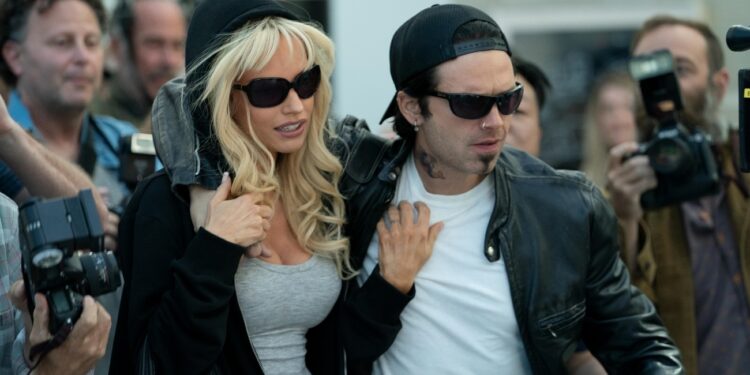 Pam & Tommy -- Set in the Wild West early days of the Internet, “Pam & Tommy” is based on the incredible true story of the Pamela Anderson (Lily James) and Tommy Lee (Sebastian Stan) sex tape. Stolen from the couple’s home by a disgruntled contractor (Seth Rogen), the video went from underground bootleg-VHS curiosity to full-blown global sensation when it hit the Web in 1997. A love story, crime caper and cautionary tale rolled into one, the eight-part original limited series explores the intersection of privacy, technology and celebrity, tracing the origins of our current Reality TV Era to a stolen tape seen by millions but meant to have an audience of just two. Pam (Lily James) and Tommy (Sebastian Stan), shown. (Photo by: Erin Simkin/Hulu)