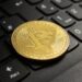 A closeup shot of a bitcoin put on a black computer keyboard