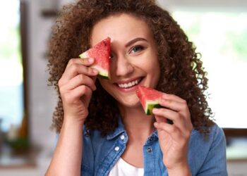 Young woman with a slice of watermelon