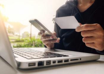 Asian business woman using laptop for online shopping.Vintage tone,Retro filter effect,Soft focus,Low light.(selective focus)