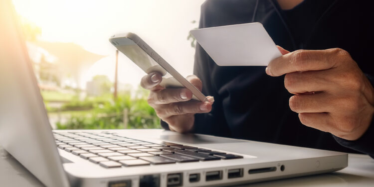 Asian business woman using laptop for online shopping.Vintage tone,Retro filter effect,Soft focus,Low light.(selective focus)