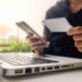 Asian business woman using laptop for online shopping.Vintage tone,Retro filter effect,Soft focus,Low light.(selective focus)