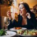 Young woman eating pasta in a cafe