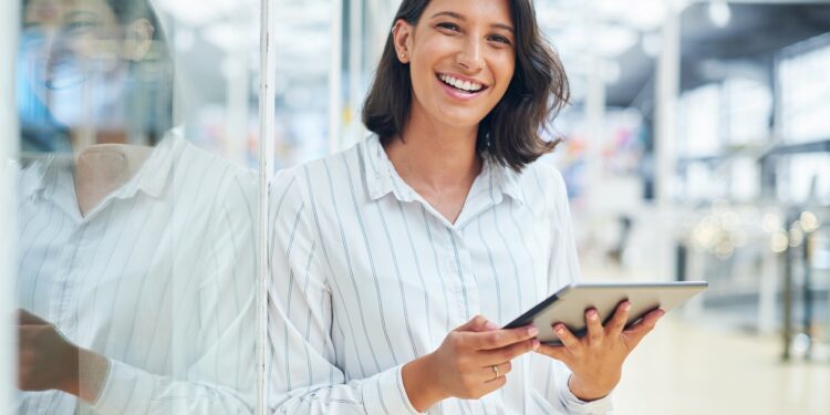 Shot of a young businesswoman using a digital tablet in a modern office