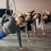 Girls team exercising aerobics together at the gym