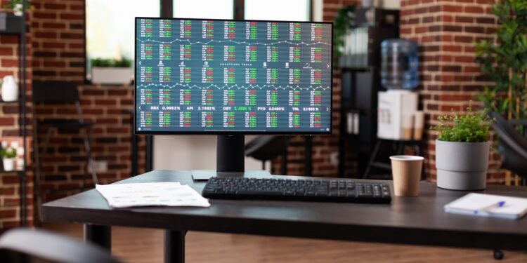 Empty office desk with stock market trend on computer, used for crypto currency investment and global economy. Monitor with money rate analysis and financial graph to make exchange profit