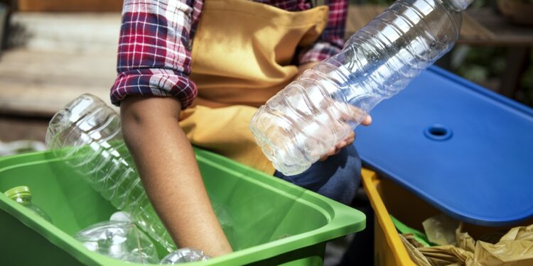 Closeup of hands separating plastic bottles