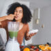 Shot of a young woman making a healthy smoothie at home