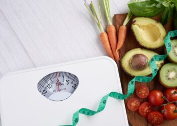 Weight loss scale with centimeter. Diet concept. Healthy food background. Food photography different fruits and vegetables. concept slimming diet fresh vegetables. top view.